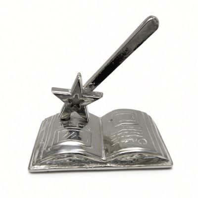 Magic wand storybook ring holder in solid pewter, a star-tipped wand on an open book, white background