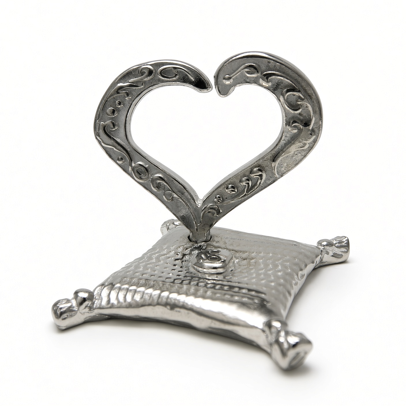 Open heart ring holder in solid pewter on a tasseled pillow base, white background