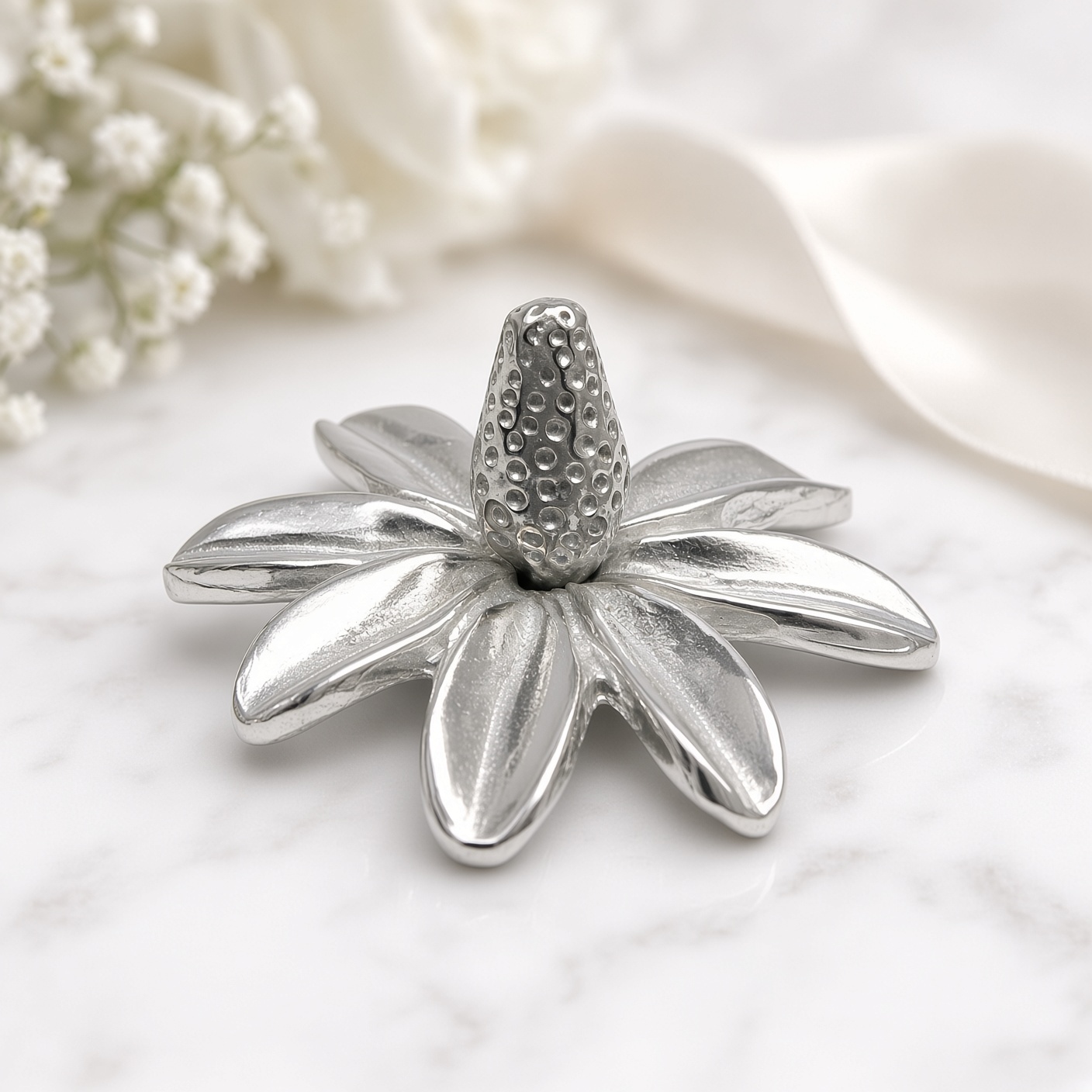 Pewter daisy ring holder on marble with baby's breath and satin