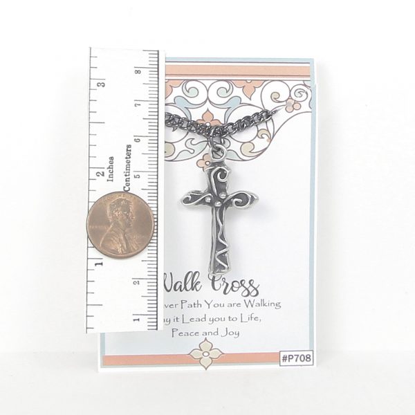 antique pewter walk cross necklace shown next to ruler for scale