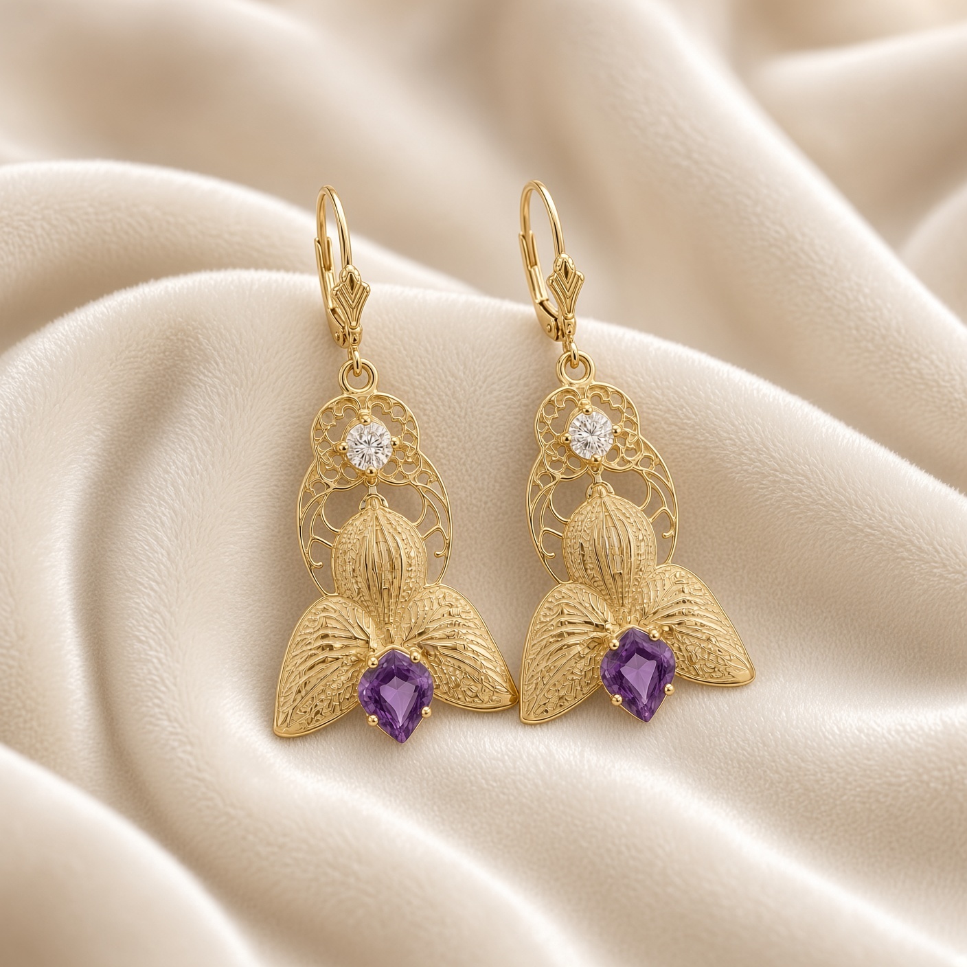14K gold orchid earrings with amethysts and diamonds on draped cream satin