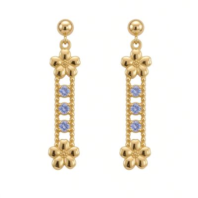 Pair of 14K yellow gold forget-me-not drop earrings with three tanzanites each on ball posts, white background